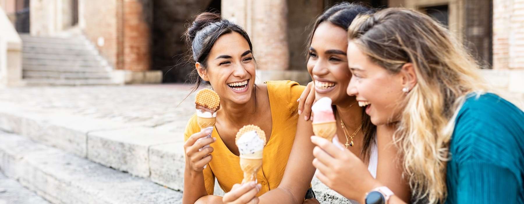 a group of friends sitting and eating ice cream