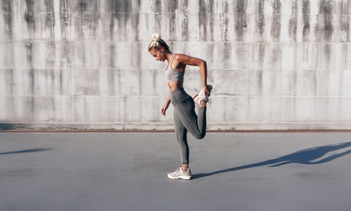 a woman stretching outdoors